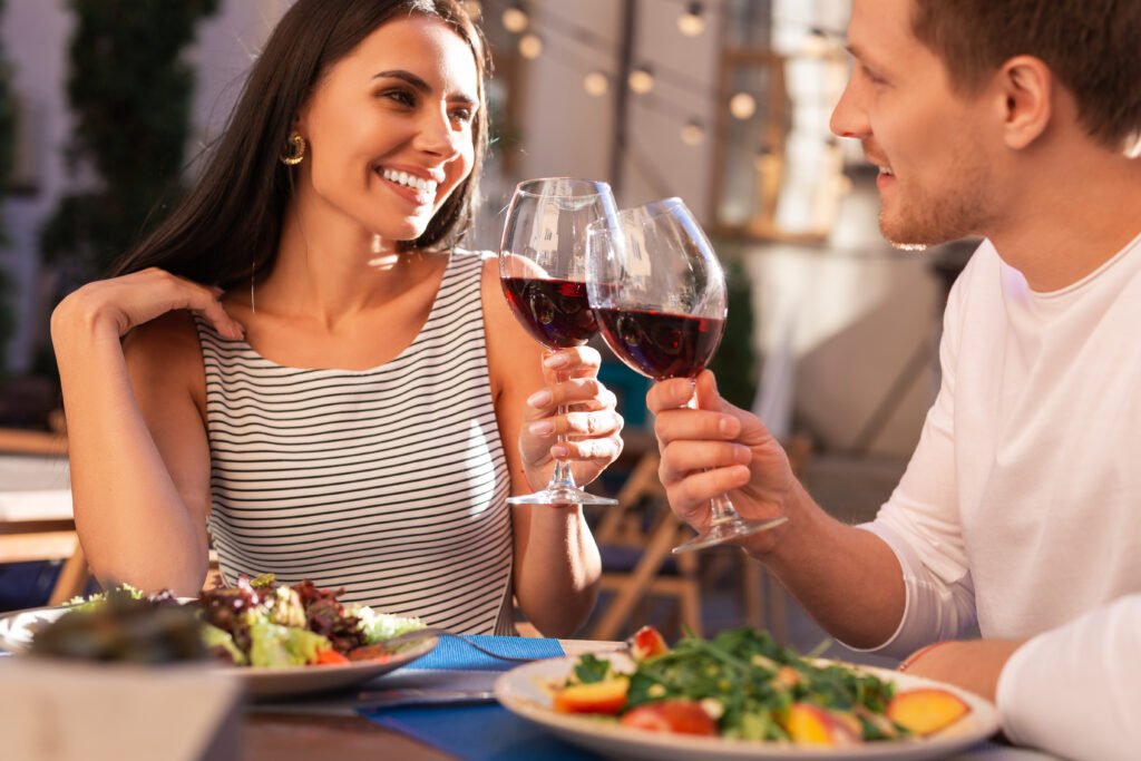 Attractive couple in natural outdoor lighting, looking confident and emotionally open on a first date