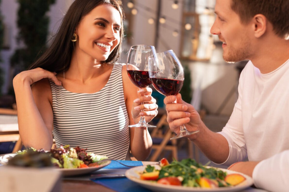 Attractive couple in natural outdoor lighting, looking confident and emotionally open on a first date