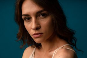 Woman looking directly into the camera with a serious and thoughtful expression, reflecting emotional awareness during a difficult moment in her relationship.
