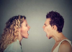 Love conversation turning into an argument between a couple facing each other and shouting
