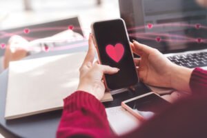 A woman holding a phone to Follow up on a dating app after first date