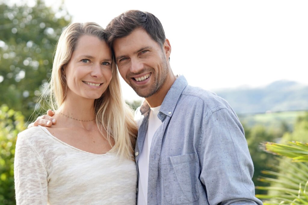 Love expressed by a smiling couple standing close together after rebuilding understanding