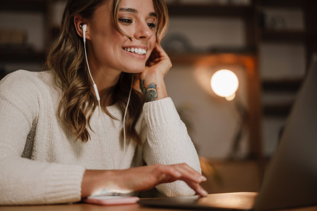 Woman smiling while listening to her partner during a long-distance relationship video call