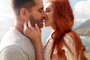 A couple sharing an intimate kiss that reflects romance rooted in emotional closeness and mutual presence.