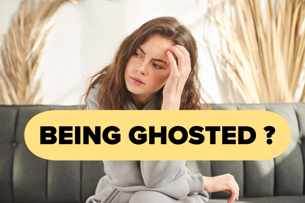 A woman sitting thoughtfully on a couch, representing emotional confusion and reflection after being ghosted in a dating situation.